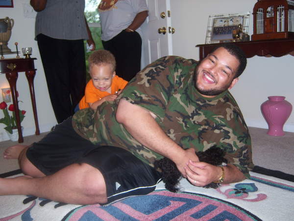 Daddy and Charles play with the dog.