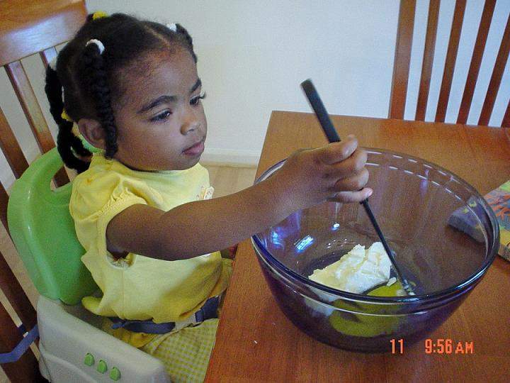 Sarai is learning to make cookies with mommy